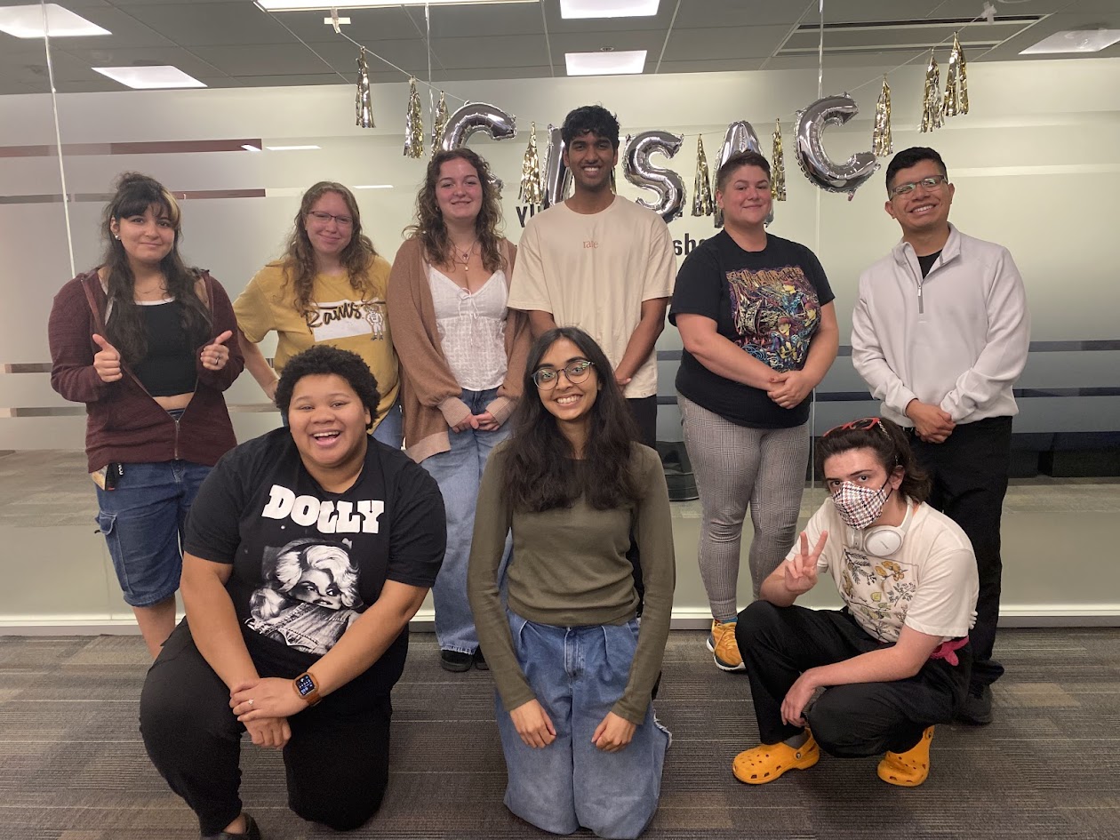 A group students standing in front of balloons