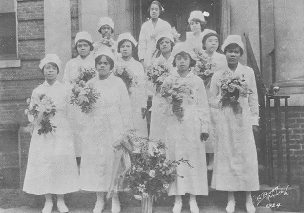 10 nursing student graduates stand outside the Phillips School of Nursing