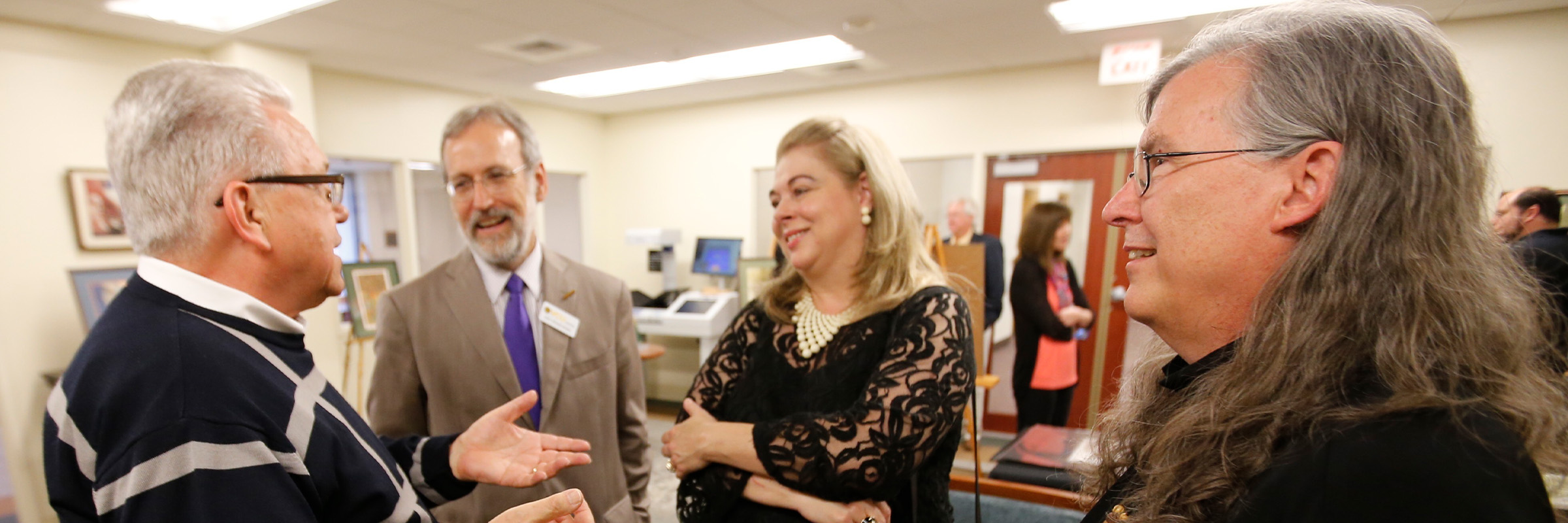 M. Thomas Inge, Ph.D., left, with his wife Donaria, then-VCU Libraries Dean John Ulmschneider, and fantasy artist and comic-book illustrator Charles Vess at a reception for Vess at James Branch Cabell Library in 2013. (Joe Mahoney