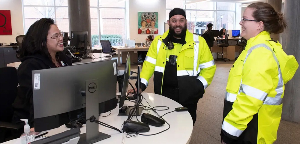 VCU Police Safety Ambassadors Denise Smith (right) and Derick Sammons (center) stop by VCU's James Branch Cabell Library as part of their routine foot patrols. Smith previously worked in the library for 15 years prior to becoming an ambassador. (Tom Kojcsich, VCU Enterprise Marketing and Communications)