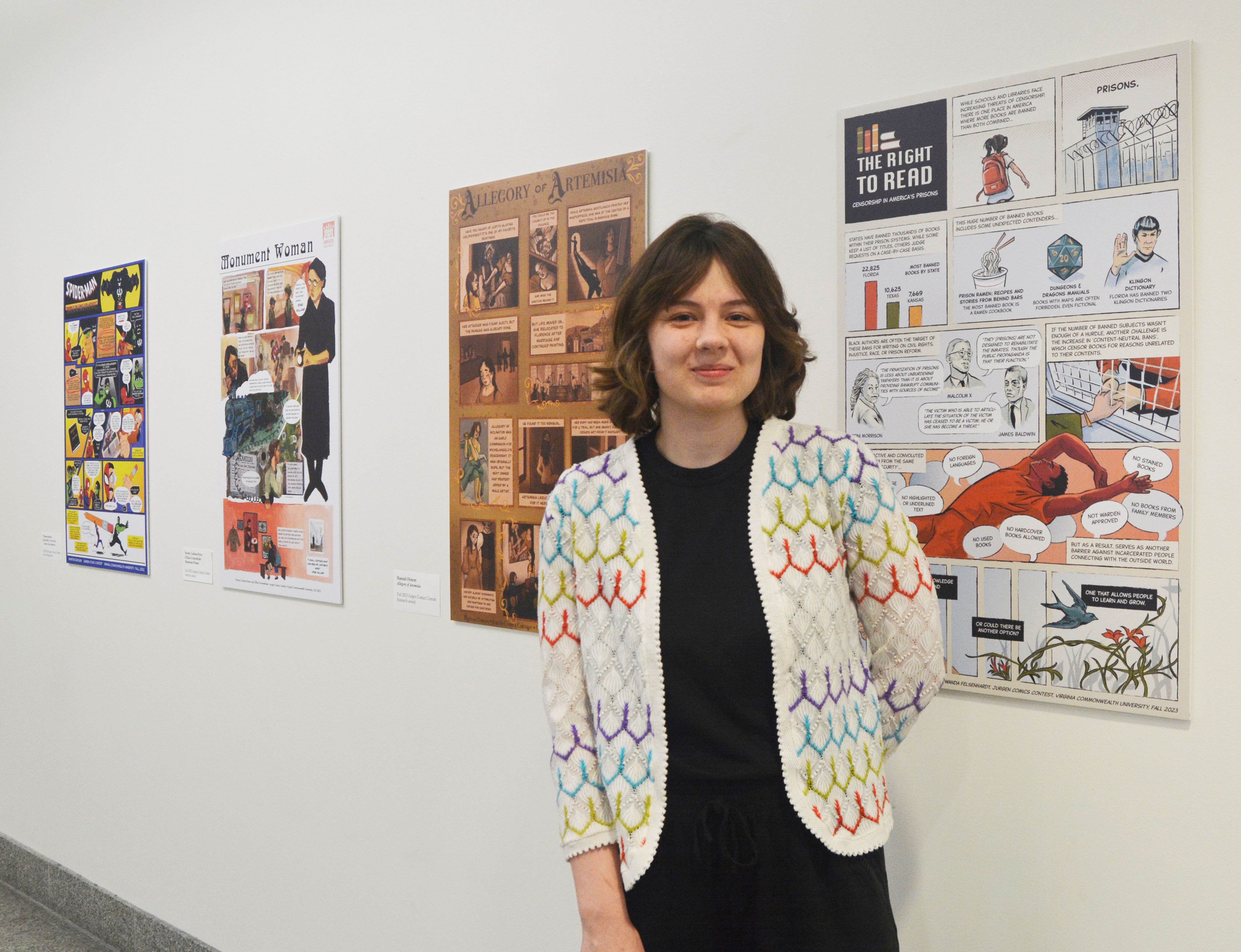 Student stands in front of their winning comic.